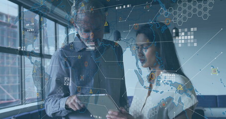 Global data network image over business professionals discussing information on tablet