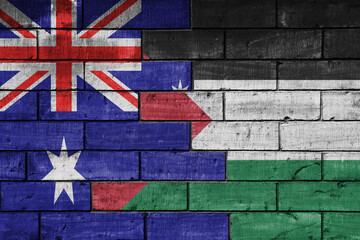 colourful painted big flag of australia and flag of palestine on a massive old brick wall...