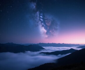 Fototapeta premium Milky Way over mountains with valley of fog at dusk