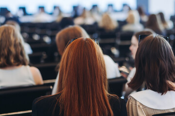 Conference with female audience, the symposium meeting, participants attendees in room hall listen...