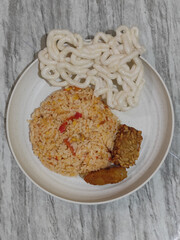 Fried rice, tempeh, crackers and fried chicken.