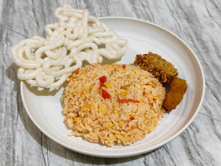 Fried rice, tempeh, crackers and fried chicken.