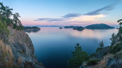 Panoramic sunset view over calm ocean, islands, and rocky cliffs.