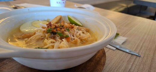 mie celor, Palembang noodle with coconut milk and egg on wooden table.