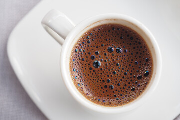 A CloseUp Image of a Traditional Coffee Cup That is Filled with Rich, Dark Brew