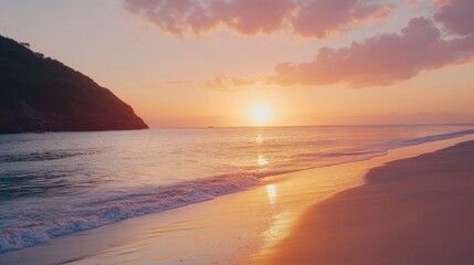 Fototapeta premium A beautiful sunset over the ocean with a beach in the background