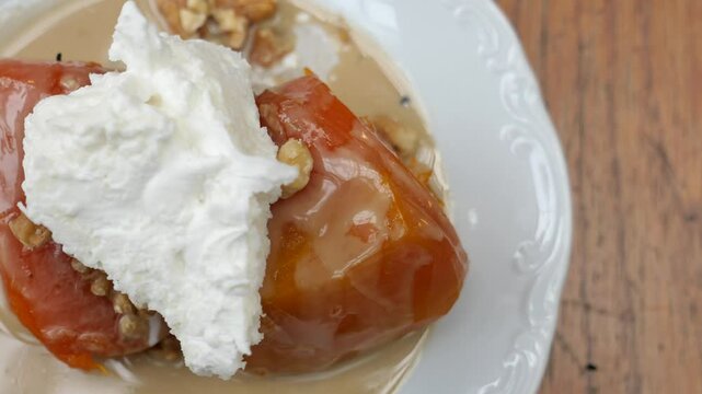 Turkish pumpkin dessert with whipped cream and walnuts