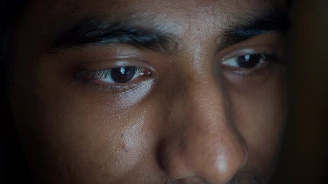 young man face suing smart phone at night 