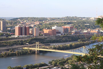 High level view of the city skyline from the river in downtown Pittsburgh, Pennsylvania during twilight.
