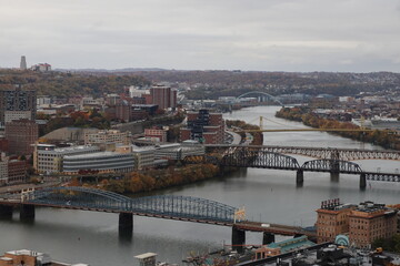 High level view of the city skyline from the river in downtown Pittsburgh, Pennsylvania during twilight.