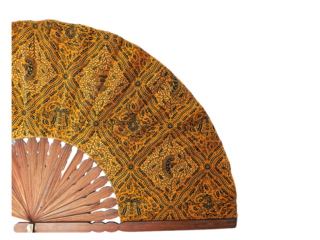 A traditional hand fan with a batik pattern isolated on a white background