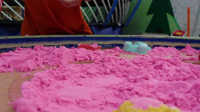 Pink synthetic sand toys that children play with to form buildings, helping children's brain development