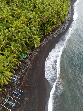 Gretek Beach, Karangasem, Bali ,Beach with black sand and coconat tree forest 