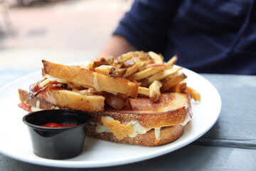 Plate full of sandwiches and french fries at a restaurant	