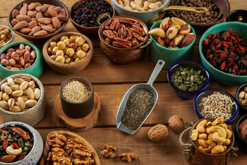 Mix of Nuts in a Different Bowls on a Wooden Table.