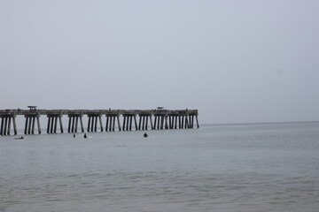 Ocean front with a sandbar and a fishing pier at Jacksonville Beach, Florida. 