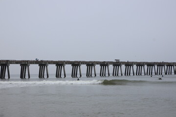 Ocean front with a sandbar and a fishing pier at Jacksonville Beach, Florida. 