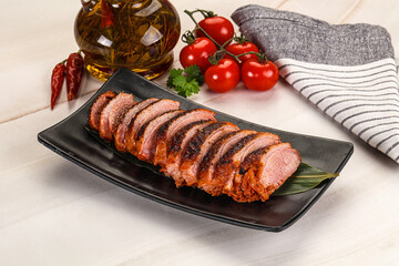 Sliced duck breast baked with cherry