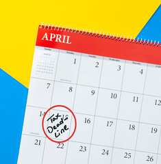 April calendar marked with a tax deadline reminder on the fifteenth with colorful background