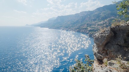 A breathtaking view of shimmering ocean water, with distant cliffs on the horizon. The sunlight creates a sparkling effect on the waves, while the cliffs add an element of grandeur to the serene