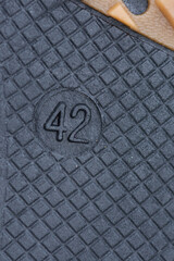 the number 42 on the black sole of the groom's shoes