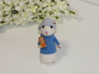 The doll is handmade. Puppet art.  A mouse made of wool.
