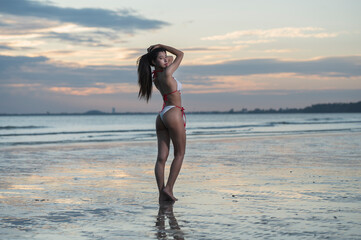 girl on the beach at sunset. woman on the beach