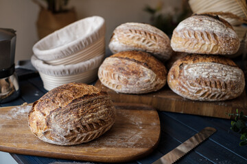 Artisan Batard Sourdough healthy Bread with leaf scoring. Open crumb high hydration Sourdough bread set on white table.