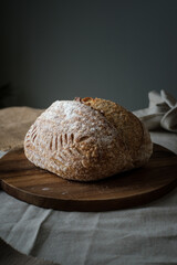 Artisan Batard Sourdough healthy Bread. Open crumb high hydration Sourdough french country bread set on dark background.