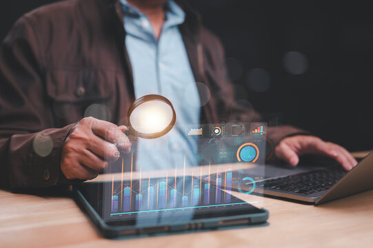 Analyzing Data Insights with Technology, Professional uses magnifying glass to examine digital graphs and data on tablet, highlighting importance of data analysis in decision-making