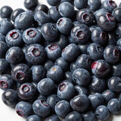 A handful of fresh blueberries scattered randomly on a white background.
