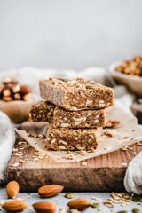 Fototapeta premium Granola and nut energy bars arranged on rustic wooden surface with crumbs