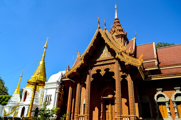 Fototapeta premium Chapel and Golden Pagoda, Lanna Architecture, Symbols of Buddhism, South East Asia at Doi Sapphanyu Temple, Mae Wang Chiangmai, Northern Thailand