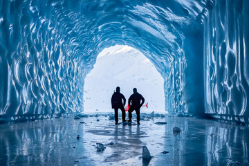 Ice Cave Explorers at the entrance of a massive ice cave in Alaska Matanuska Glacier showcase...