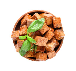 Wooden bowl with pieces of fried tofu cheese and basil on white background