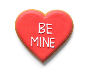 Red heart shaped cookie with word BE MINE on white background. Valentine's day celebration