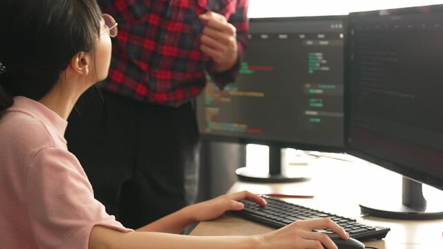 Slow motion back end or software developer manager supervising his team on new application program development on debugging and solving complex code algorithms on monitor. Burgeoning