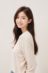 A woman with long hair is wearing a white shirt and smiling