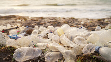 sea pollution, plastic water bottles, ocean waves in background, marine debris beach