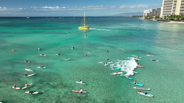 Drone Aerial View of Surfers Riding Waves in Hawaii Sea with Surfboards in the Blue transparent Ocean 