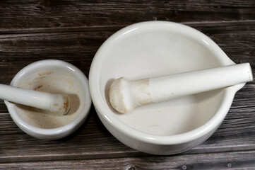 white porcelain mortar and pestle set, a set of two simple tools used to prepare ingredients or substances by crushing and grinding them into fine paste or powder in kitchen, laboratory and pharmacy