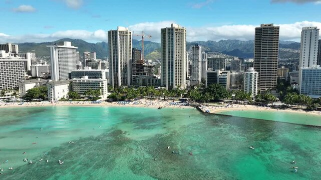 Drone Aerial View of Surfers and Waikiki Beach with Iconic Hotels in Hawaii