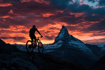 Fototapeta premium A mountain biker silhouetted against a dramatic sky, with the iconic Matterhorn summit in the background, symbolizing adventure and exploration during summer biking season