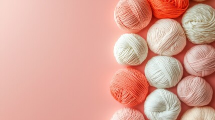 Soft and Cozy Yarn Balls in Various Colors on a Gentle Pink Background for Craft and DIY Projects