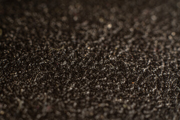 Rich textured black fabric offers a glimpse into vintage textile design with intricate details
