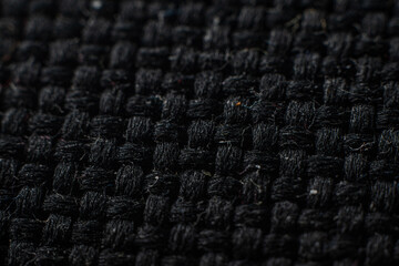 Textured black fabric with woven pattern showcasing fine craftsmanship and elegance