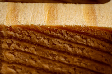 Rich brown wood texture reveals natural patterns in close-up view of an oak plank