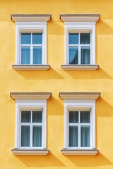 Obraz premium Yellow Building with Three Windows