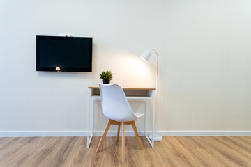 This spacious room features a functional desk with an ergonomic chair, along with a stylish...