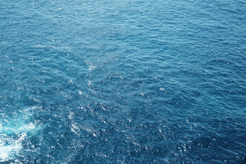 Emerald green waters and turquoise surface of calm blue sea wave and water sparkling sunlight reflects off the surface of the sea. Travel destination summer of ocean
